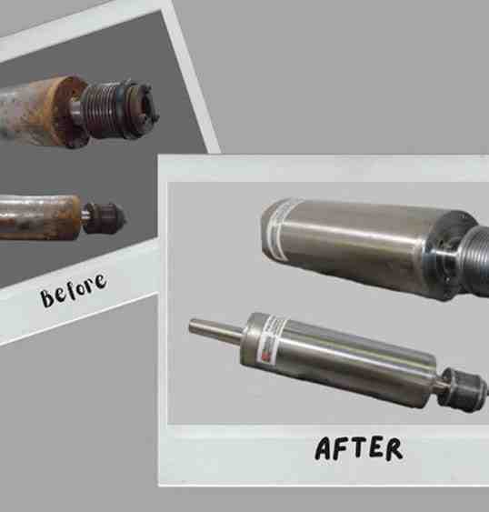 A TECHNICIAN CAREFULLY PRESSING A NEW BEARING ONTO A SPINDLE SHAFT - SPINDLE BEARING REPLACEMENT PROCEDURE